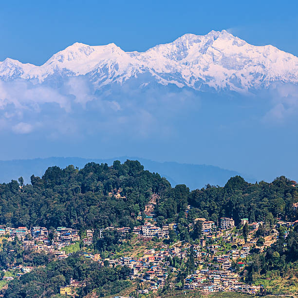 Panoramic view of Darjeeling with mount Kanchengjunga in the background "Panoramic view of Darjeeling with mount Kanchengjunga in the background. Kangchenjunga is the third highest mountain in the world, with an elevation of 8,586 m and located along the India-Nepal border in the Himalayas." kangchenjunga stock pictures, royalty-free photos & images
