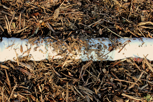 View of the drainage pipe of a composting windrow under construction, to collect the slurry generated in the composting process of decomposing organic matter.