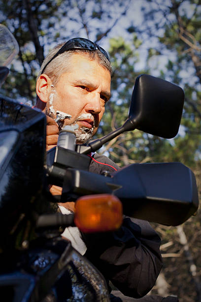 istock Biker Man Shaving With Razor on Motorcycle's Mirror 174750959