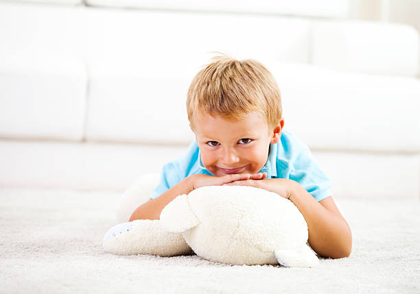 istock Portrait of a cute boy lying down on white carpet 174751358