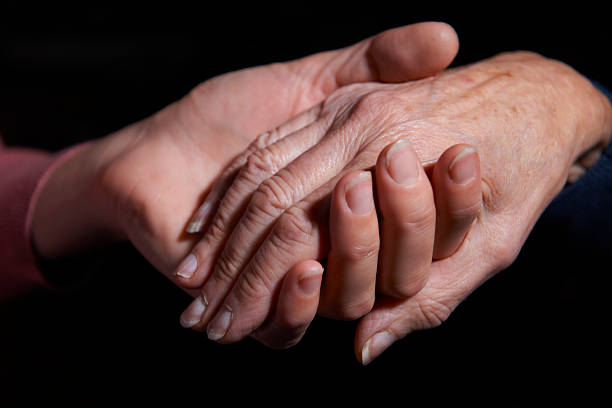 istock Young Woman Holding Older Woman's Hand 174751451
