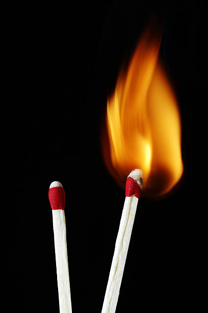 Matches - One On Fire Contrast of two matches. One lit...the other not.Lots of metaphoric uses for business. unlit match stock pictures, royalty-free photos & images