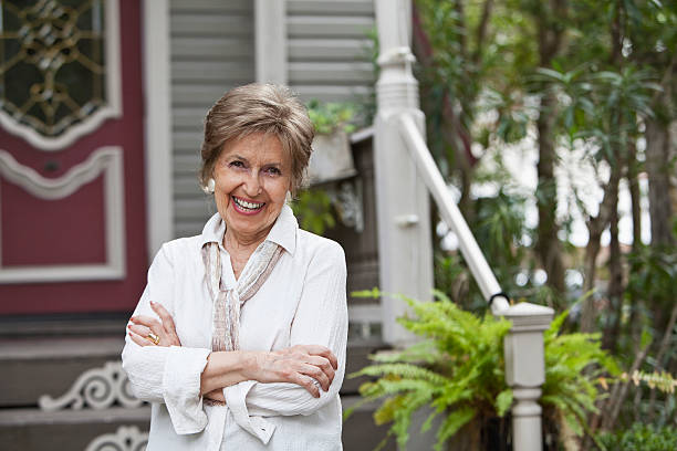 istock Elderly woman in front of home 174752200