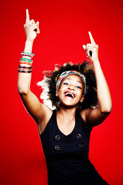 istock Cute young woman with Caribbean vibe dances, laughing 174752400
