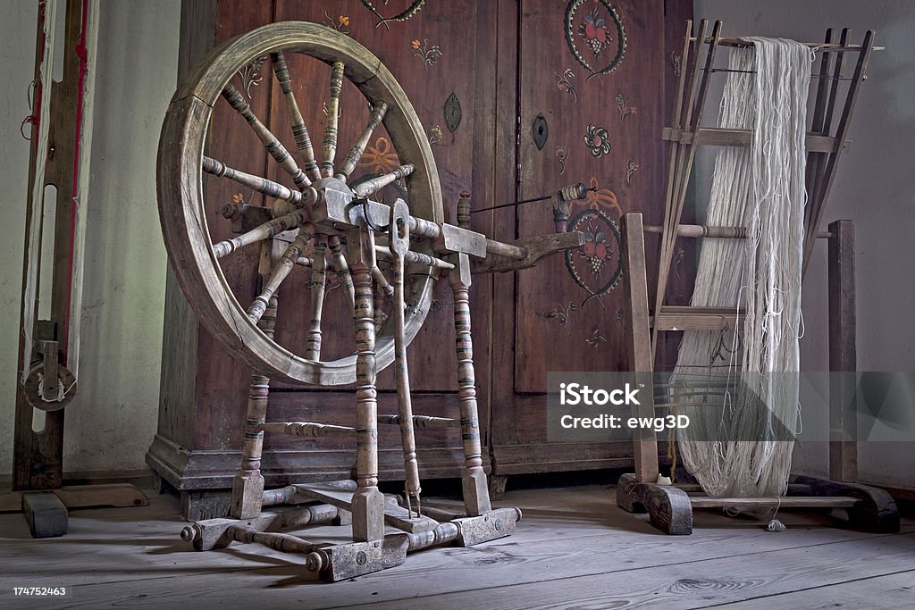 Old weaving room "Toned image scene  with an old Spinning wheel, weaving loom and vintage wardrobe in room interior poor peasant from the early twentieth century, Germany. See more OLD INTERIORS images here:" Spinning Wheel Stock Photo