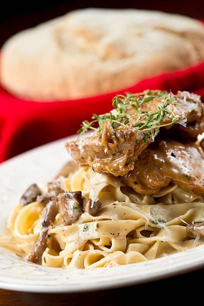 Chicken Marsala Chicken Marsala over Home-Made Pasta cooked selective focus vertical pasta stock pictures, royalty-free photos & images