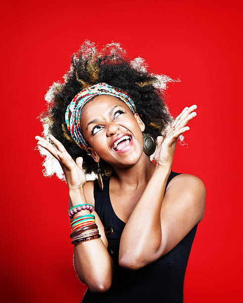 istock Vivacious young woman with Afro gestures and sings, smiling 174753390