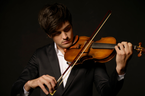 studio portrait of a violinist with long hair