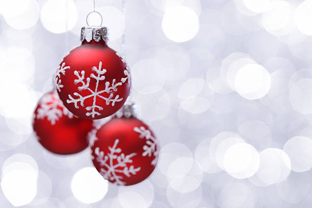 istock Hanging red christmas balls on silver illuminated background 174754016