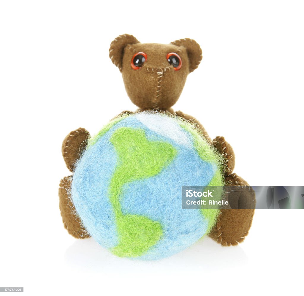 Childhood World A teddy bear holding a felted world (both made by me). Isolated on white. Globe - Navigational Equipment Stock Photo