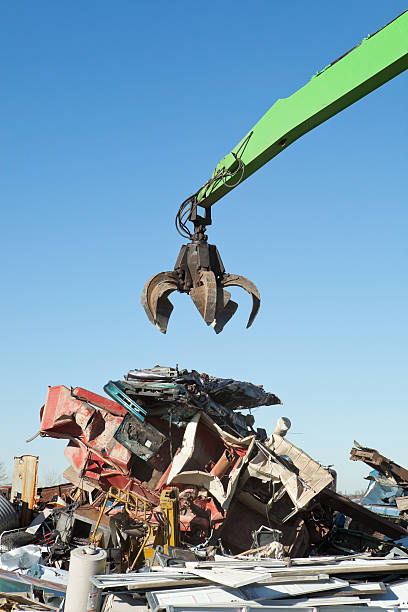 istock Salvage Yard Grappling Claw Above Crushed Cars and Scrap Pile 174754330