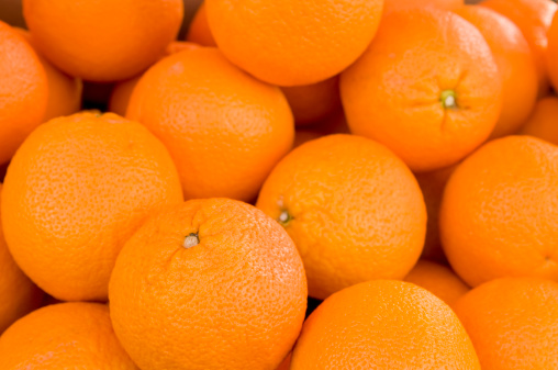 Many fresh oranges at a market stall