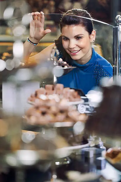 girl shopping and admireing  different chocolate goodies through shop