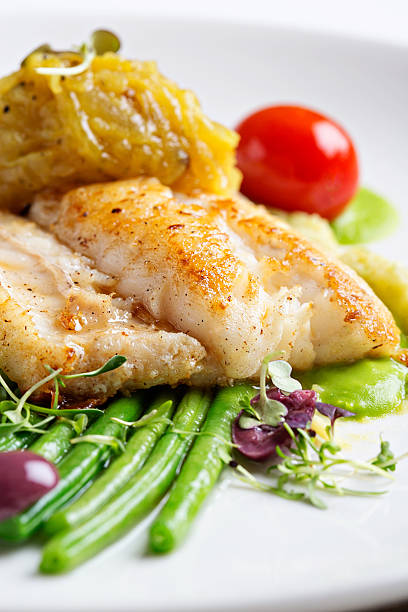 istock Green beans, olives and tomato accompany restaurant grilled fish 174755755