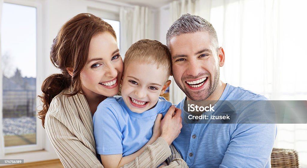 Happy Family Portrait of happy family embracing and laughing at the camera. Child Stock Photo