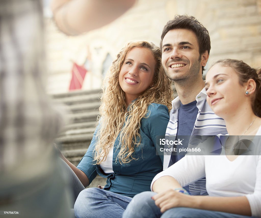 Group of friends sitting outside Group of guys sitting outside Adolescence Stock Photo
