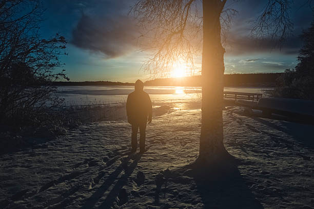 istock Man standing against sunset in Sweden during Winter 174757703