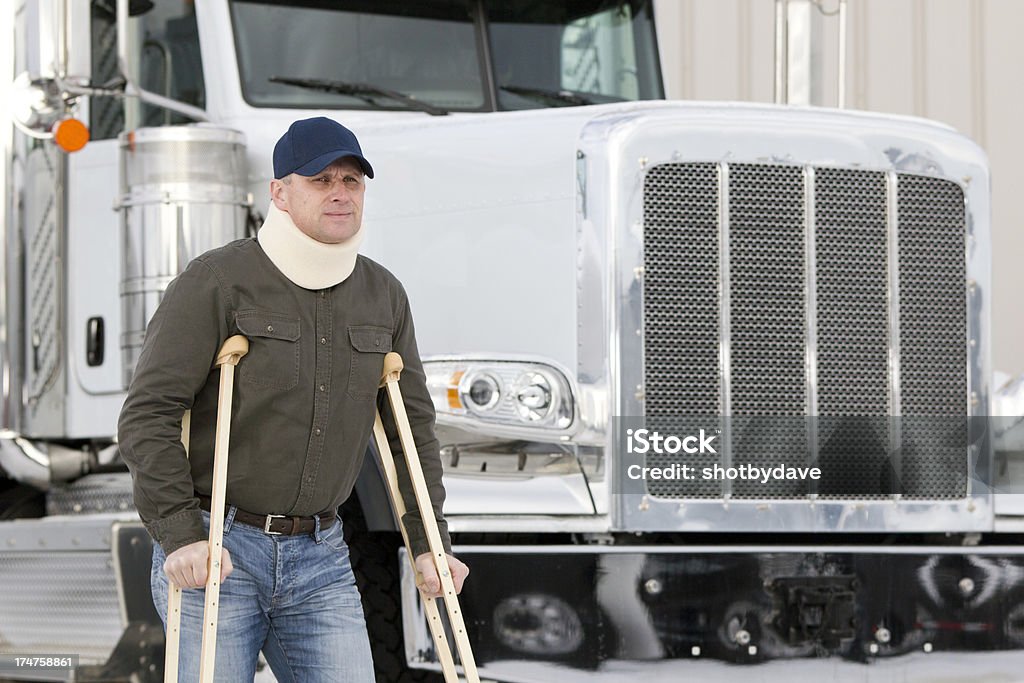 Truck Driver and Disablity A royalty free image from the trucking industry of a truck driver on crutches. Trucking Stock Photo