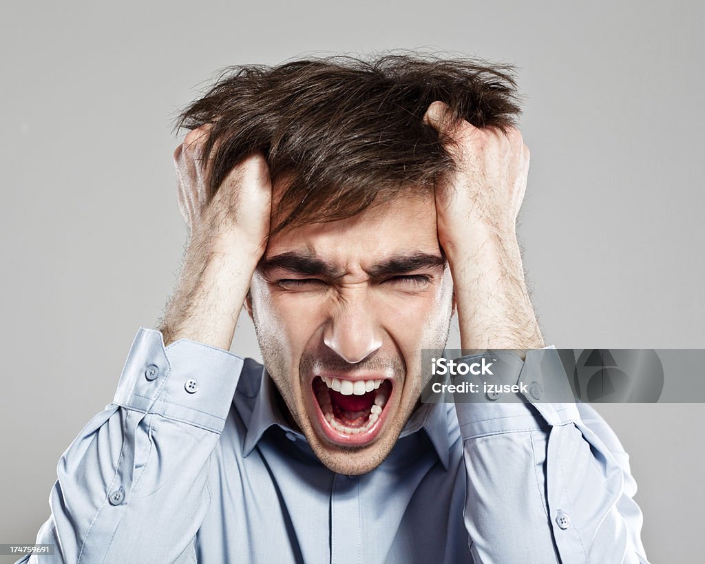 Frustration Portrait of young businessman screaming with his hands in hair. 25-29 Years Stock Photo