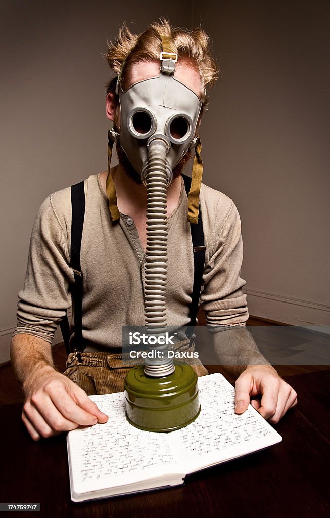 Gas Mask Study Man wearing a Gas Mask Study or Reading - Shot at Raliegh'Lypse 2012 Adult Stock Photo