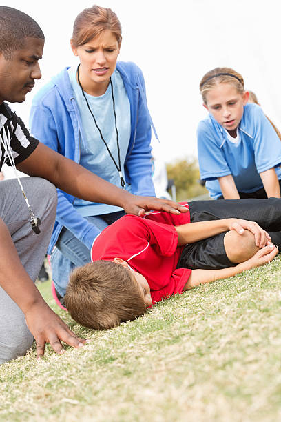 istock Concerned referee and coach with injured soccer player 174760511
