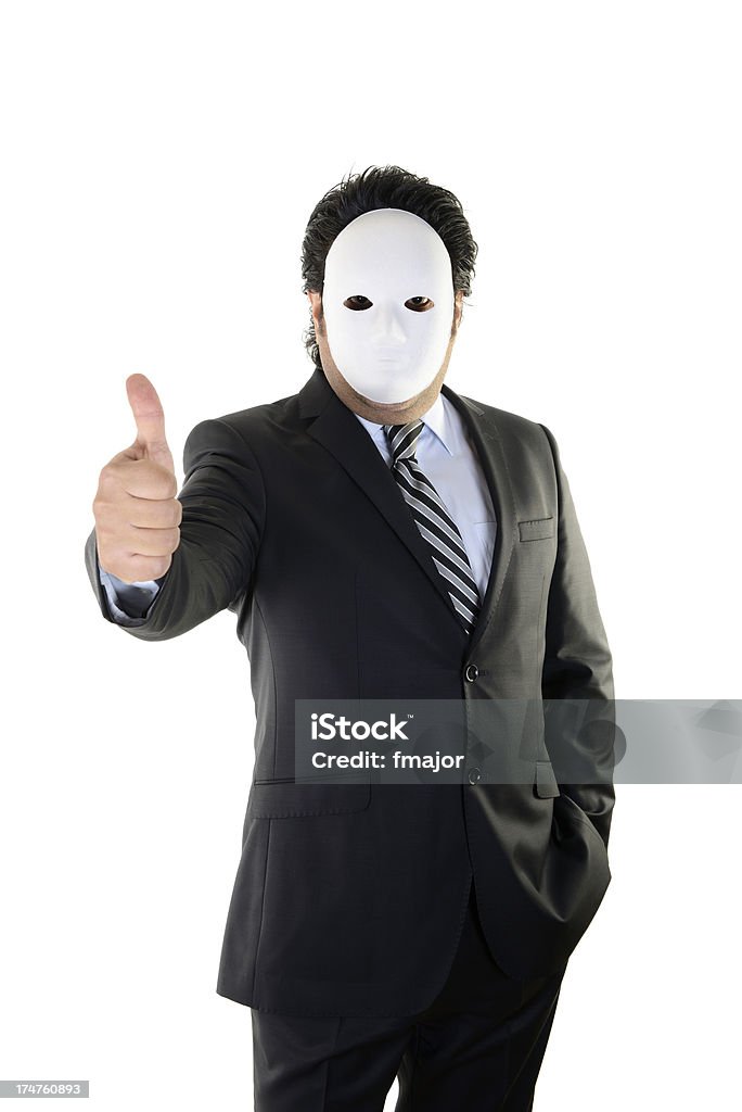 Hiding Businessman, thums up, studio shot.He is hiding behind a mask Adult Stock Photo