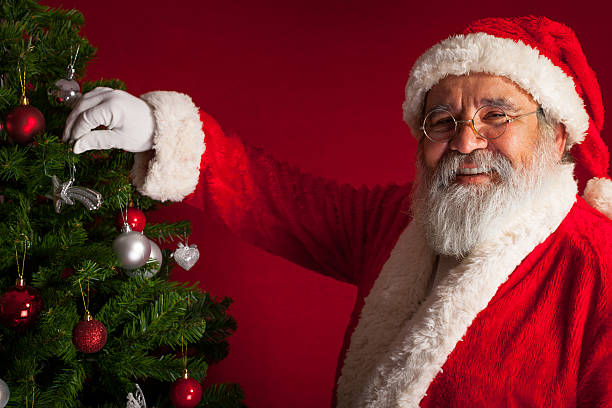 istock Santa Claus decorates a Christmas tree 174760963