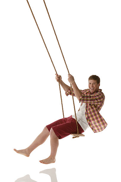 istock Attractive happy young man swinging on a swing 174761435