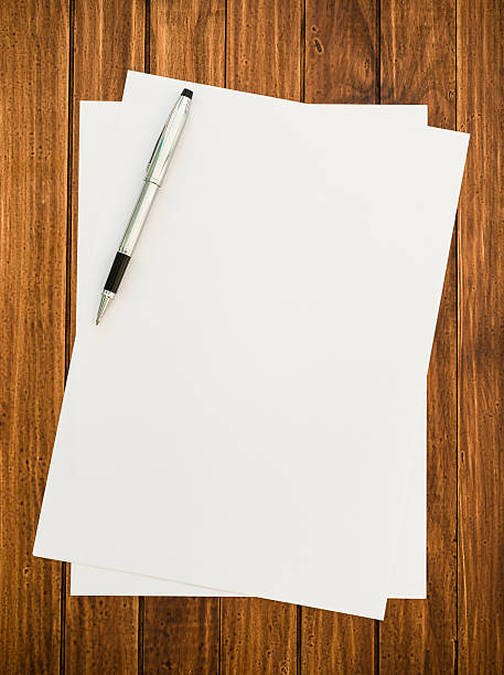 istock Pen and white paper on the wood desk 174761635