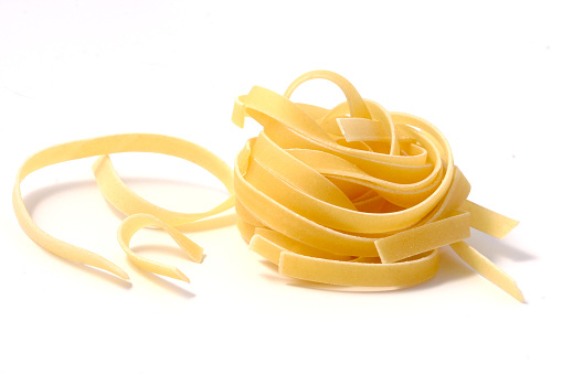 uncooked pasta on white background