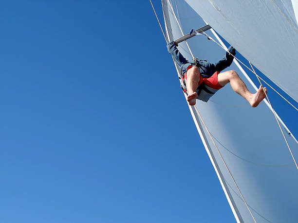 sails under repair emergency on the sailboat... get up to the top and do some repairations. school sport high up tall stock pictures, royalty-free photos & images