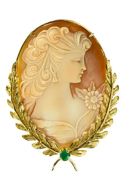 Shell cameo of victorian lady in gold setting with emerald.