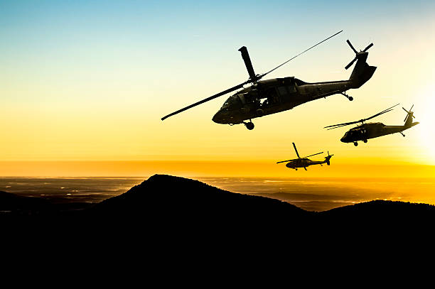 istock Three flying army helicopters on sunset background 174763171