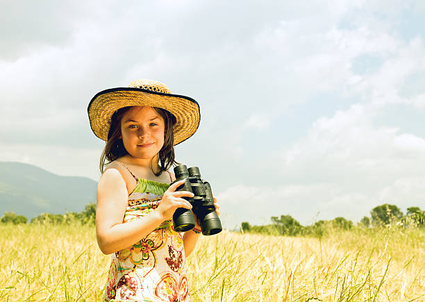 istock Country girl with binoculars 174763236