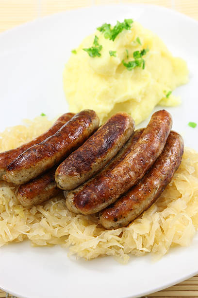 cooking sauerkraut with sausages, street restaurant in Trento, Italy