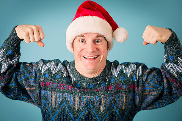 istock Man With Excited Look Wearing Santa Hat and Ugly Sweater 174763537