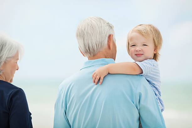 istock Little boy With Grandparents At Beach 174763688