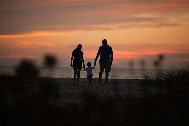 istock Family Walking At Beach During Sunset 174763835