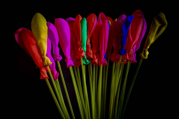 Balloons of various colors on a black background.