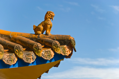Lion on the roof of a chinese temple.