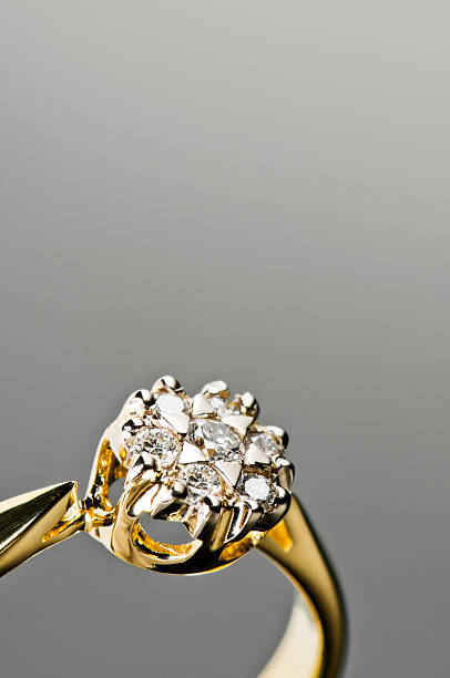 istock Close-up of gold ring with diamonds isolated on gray 174764122