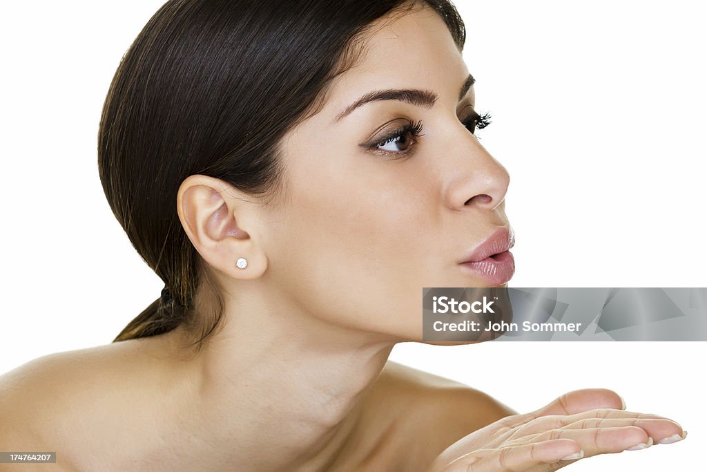 Woman blowing a kiss Closeup of a beautiful young woman blowing a kiss  Kissing Stock Photo