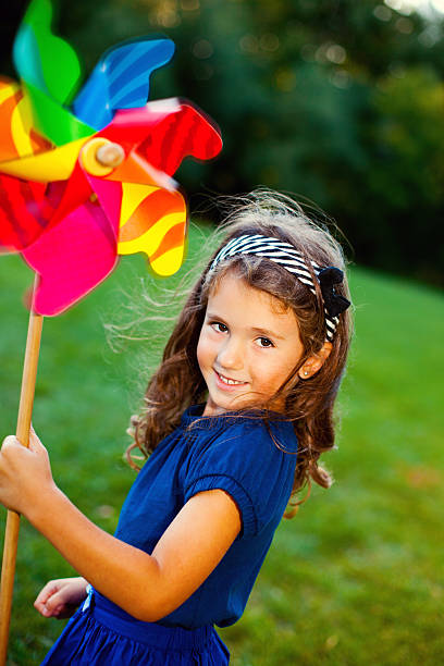 istock Happy girl with a pinwheel 174764342