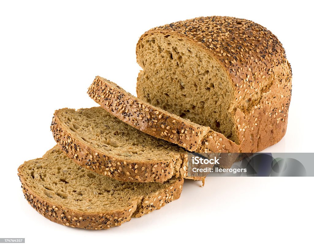 Wholemeal seeded brown bread on a white background Multi seeded sliced loaf of bread on a white background. Loaf of Bread Stock Photo