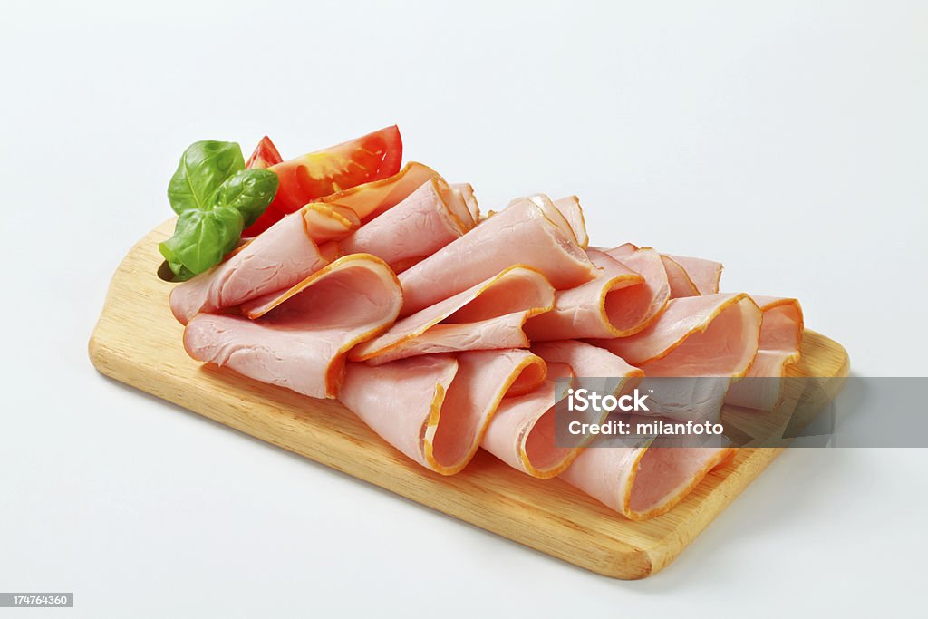 Slices of smoked ham on a cutting board Appetizer Stock Photo