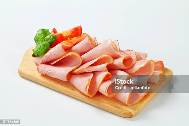 Slices Of Smoked Ham On A Cutting Board Stock Photo - Download Image Now - Appetizer, Bacon, Basil