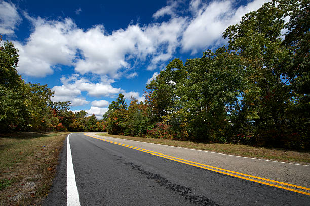 Two-lane highway through the Ozark Mountains in the fall.