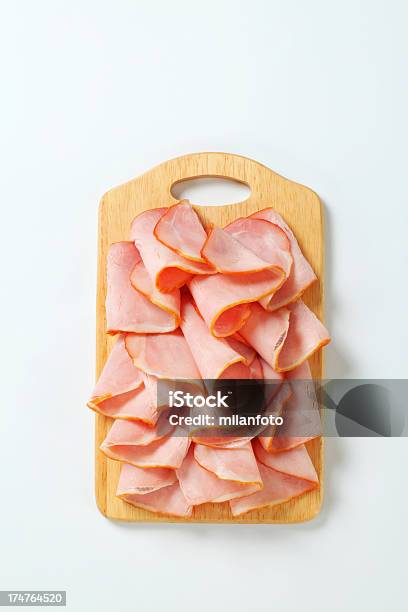 Slices Of Smoked Ham On A Cutting Board Stock Photo - Download Image Now - Ham, Slice of Food, White Background