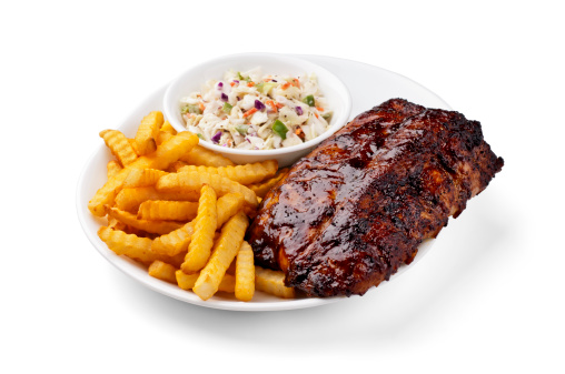 Baby back ribs with french fries and coleslaw on white with clipping path.  Please see my portfolio for other food related images.
