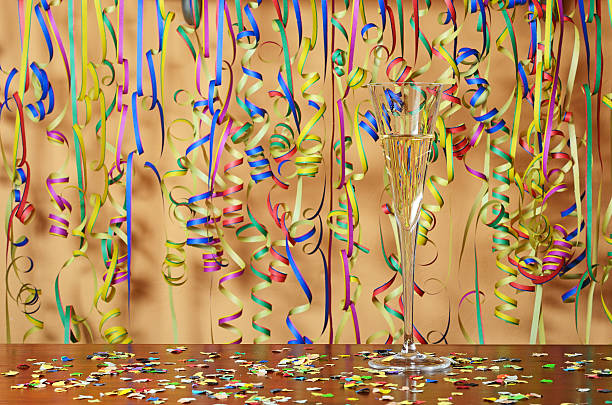 Happy New Year glass of champagne and paper streamer confetti stock photo